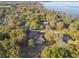 Scenic aerial view of a home nestled among lush trees near a tranquil lake at 5261 Waterwood Dr, Bartow, FL 33830
