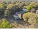 Aerial view of a single-Gathering home with a pool surrounded by mature trees at 5261 Waterwood Dr, Bartow, FL 33830