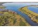 Beautiful aerial view of a vast lake with lush shoreline and vibrant blue water at 5261 Waterwood Dr, Bartow, FL 33830