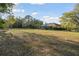 Sprawling backyard with lush grass surrounding home and screened in lanai at 5261 Waterwood Dr, Bartow, FL 33830