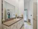 Bright bathroom featuring a large mirror with decorative tile and a doorway leading to another room at 5261 Waterwood Dr, Bartow, FL 33830