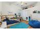 Bright, colorful bedroom features a ceiling fan, a twin bed, and an inviting blue beanbag chair at 5261 Waterwood Dr, Bartow, FL 33830