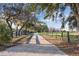 Long private driveway lined with mature trees, leading to a secluded estate at 5261 Waterwood Dr, Bartow, FL 33830