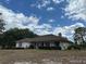 A charming single-story home with a classic exterior design, surrounded by a well-manicured lawn and lush landscaping at 5261 Waterwood Dr, Bartow, FL 33830