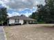 Charming one-story home with a well-maintained lawn, mature trees, and a long driveway at 5261 Waterwood Dr, Bartow, FL 33830