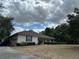 Well-maintained home featuring a lush lawn, tidy landscaping, and an attached two-car garage at 5261 Waterwood Dr, Bartow, FL 33830