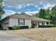 Ranch-style house featuring a side garage, complemented by mature landscaping and a covered front porch at 5261 Waterwood Dr, Bartow, FL 33830