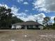Inviting home with a manicured lawn, charming shutters, and a classic, covered front porch at 5261 Waterwood Dr, Bartow, FL 33830