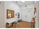 Bright foyer with hardwood floors, coat rack, a padded bench, and a double front door at 5261 Waterwood Dr, Bartow, FL 33830