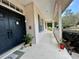 Inviting front porch with potted plants and dual entry doors, adding curb appeal to this cozy home at 5261 Waterwood Dr, Bartow, FL 33830