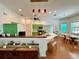 Bright kitchen features green cabinets, modern appliances, and an adjacent dining area with lots of light at 5261 Waterwood Dr, Bartow, FL 33830
