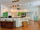 Modern kitchen with green cabinets, pendant lights, an island, and an open floor plan at 5261 Waterwood Dr, Bartow, FL 33830