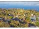 Aerial view of a lake and lakefront homes surrounded by lush trees at 5261 Waterwood Dr, Bartow, FL 33830