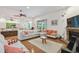 Open-concept living space connects living room and kitchen with stylish furnishings and a brick fireplace at 5261 Waterwood Dr, Bartow, FL 33830