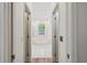 Hallway view of a Main bathroom featuring a soaking tub under a window at 5261 Waterwood Dr, Bartow, FL 33830