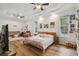 Large main bedroom with hardwood floors, natural light, and a tray ceiling at 5261 Waterwood Dr, Bartow, FL 33830