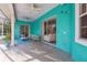 A spacious turquoise-painted patio with ample seating, an outdoor rug and a view of the pool at 5261 Waterwood Dr, Bartow, FL 33830