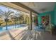 A covered outdoor patio featuring a seating area and a view of the pool and backyard at 5261 Waterwood Dr, Bartow, FL 33830