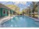 This home features a large in-ground swimming pool inside of a screened enclosure, creating the ideal space for entertainment at 5261 Waterwood Dr, Bartow, FL 33830