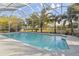 This home features a large in-ground swimming pool inside of a screened enclosure with plenty of surrounding deck space at 5261 Waterwood Dr, Bartow, FL 33830