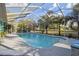 Screened in pool with lush landscaping providing a private backyard retreat at 5261 Waterwood Dr, Bartow, FL 33830