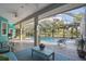 A screened in pool with an outdoor seating area and lush landscaping surrounding the pool at 5261 Waterwood Dr, Bartow, FL 33830