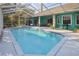 Beautiful screened-in swimming pool with an expansive patio and colorful house exterior at 5261 Waterwood Dr, Bartow, FL 33830