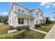 Charming townhome with light blue and white exterior, well-manicured lawn, and inviting front porch at 1324 Painted Bunting Ave, Winter Garden, FL 34787