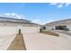 View of a row of garages, each with a private driveway and neat landscaping at 1324 Painted Bunting Ave, Oakland, FL 34787