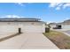 Townhouse garages with driveways and manicured landscaping, creating a clean and orderly street appeal at 1324 Painted Bunting Ave, Oakland, FL 34787