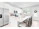 Modern kitchen with stainless steel appliances, white cabinetry, and a spacious center island with barstool seating at 1324 Painted Bunting Ave, Winter Garden, FL 34787