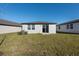 The home's backyard is a spacious, grassy lawn with a modern privacy fence at 2530 Linda Knoll Ln, Bartow, FL 33830