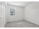 A clean bedroom featuring light gray carpet and a window at 2530 Linda Knoll Ln, Bartow, FL 33830