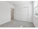 A clean bedroom featuring light gray carpet, a window, and a closet with sliding doors at 2530 Linda Knoll Ln, Bartow, FL 33830