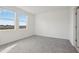 A gray carpeted bedroom with white walls and two windows at 2530 Linda Knoll Ln, Bartow, FL 33830