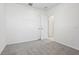 A gray carpeted bedroom with white walls and an open closet door at 2530 Linda Knoll Ln, Bartow, FL 33830