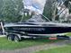 Malibu Wakesetter boat in black and white with a custom trailer, ready for a lake day at 3254 E Canal Ln, Fort Meade, FL 33841