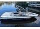 Malibu Wakesetter boat in black and white, sitting at a dock, is ready for the lake at 3254 E Canal Ln, Fort Meade, FL 33841