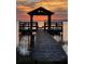 Waterfront sanctuary boasting a covered dock, a peaceful hammock, and mesmerizing sunset vistas at 3254 E Canal Ln, Fort Meade, FL 33841