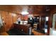 Rustic kitchen with wood paneling, island, and modern appliances at 3254 E Canal Ln, Fort Meade, FL 33841