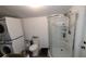 Clean bathroom with a curved glass shower and stacked washer/dryer at 3254 E Canal Ln, Fort Meade, FL 33841