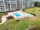 Aerial view of building and pool with shuffleboard court on lake front property at 700 Mirror Nw Ter # 505, Winter Haven, FL 33881