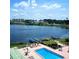 Aerial view of the lake and pool area, plus surrounding landscape and residential buildings at 700 Mirror Nw Ter # 505, Winter Haven, FL 33881