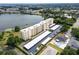 An aerial view of the condominium, the covered parking, and the lake at 700 Mirror Nw Ter # 505, Winter Haven, FL 33881