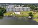 Aerial view of building with pool, dock and boat slips on the lake at 700 Mirror Nw Ter # 505, Winter Haven, FL 33881