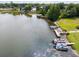 Aerial view of waterfront with multiple boats docked and surrounded by lush greenery at 700 Mirror Nw Ter # 505, Winter Haven, FL 33881