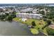 An aerial view of a building, pool, and boat slips overlooking a lake at 700 Mirror Nw Ter # 505, Winter Haven, FL 33881