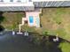 Overhead view of the building with a pool, shuffleboard court, private boat docks, and lake access at 700 Mirror Nw Ter # 505, Winter Haven, FL 33881