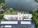 Aerial view of a condo complex with lake access, pool, parking and landscaped grounds at 700 Mirror Nw Ter # 505, Winter Haven, FL 33881