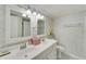 Bathroom featuring a double sink vanity, decorative wallpaper and marble countertops at 700 Mirror Nw Ter # 505, Winter Haven, FL 33881